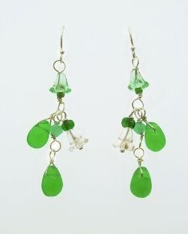 These playful green dangling earrings evoke memories of springtime flowers. Colors range from a clear bead, soft green raindrop shaped beads and dark green accents. Earring falls 1.5 inches past lobe and has sterling silver hooks. Green Nickel Free Dangle Earrings, Green Chandelier Earrings With Dangling Beads As A Gift, Green Nickel Free Dangle Chandelier Earrings, Green Drop Jewelry For Jewelry Making, Green Teardrop Earrings For Jewelry Making, Green Long Drop Jewelry With Dangling Beads, Green Teardrop Drop Earrings For Jewelry Making, Green Long Drop Earrings, Green Teardrop Jewelry With Ear Wire