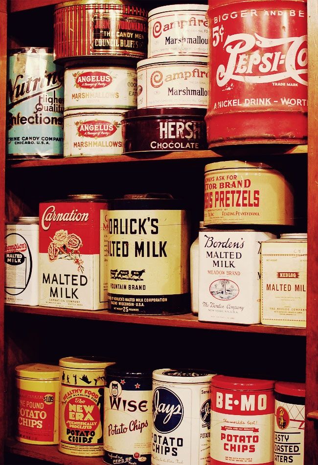 an old wooden shelf filled with lots of different types of milk