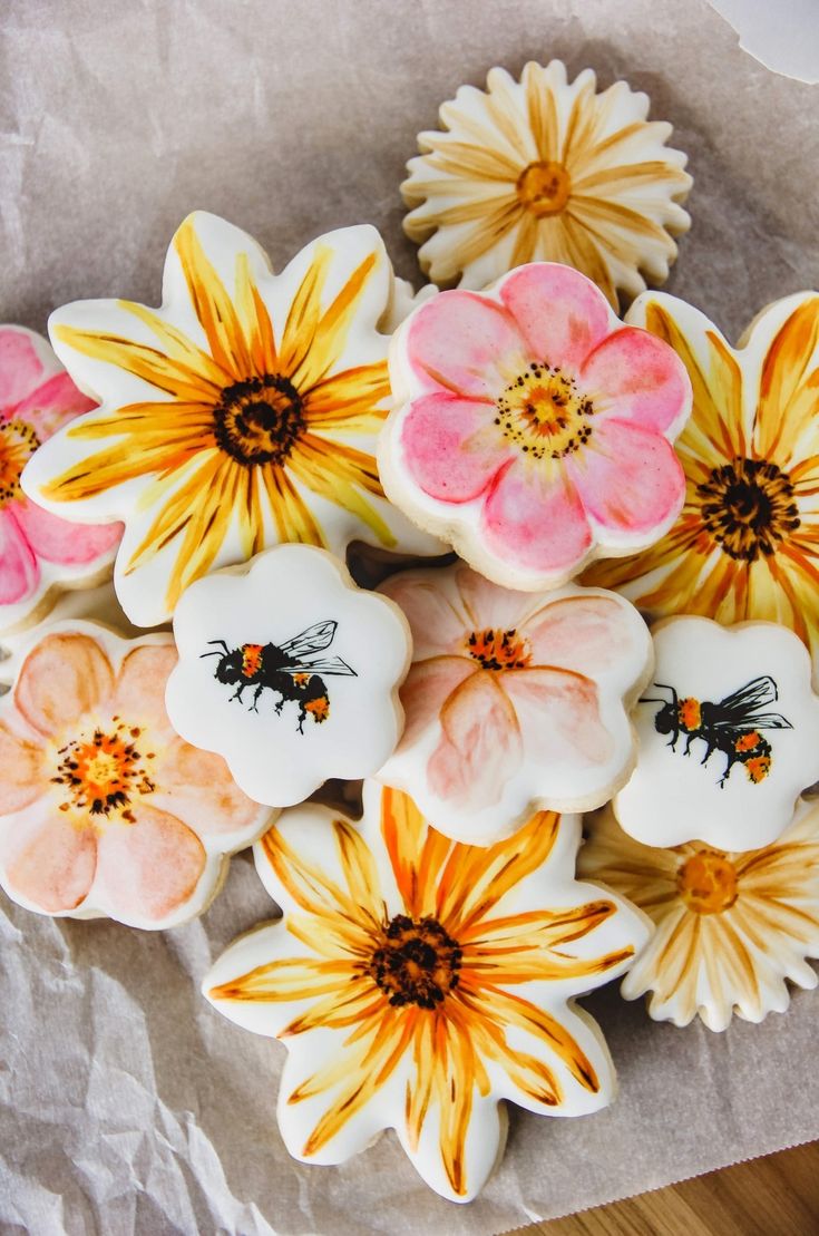 decorated cookies with flowers and bees on them