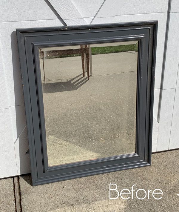 a mirror sitting on the side of a building next to a wall with words before and after