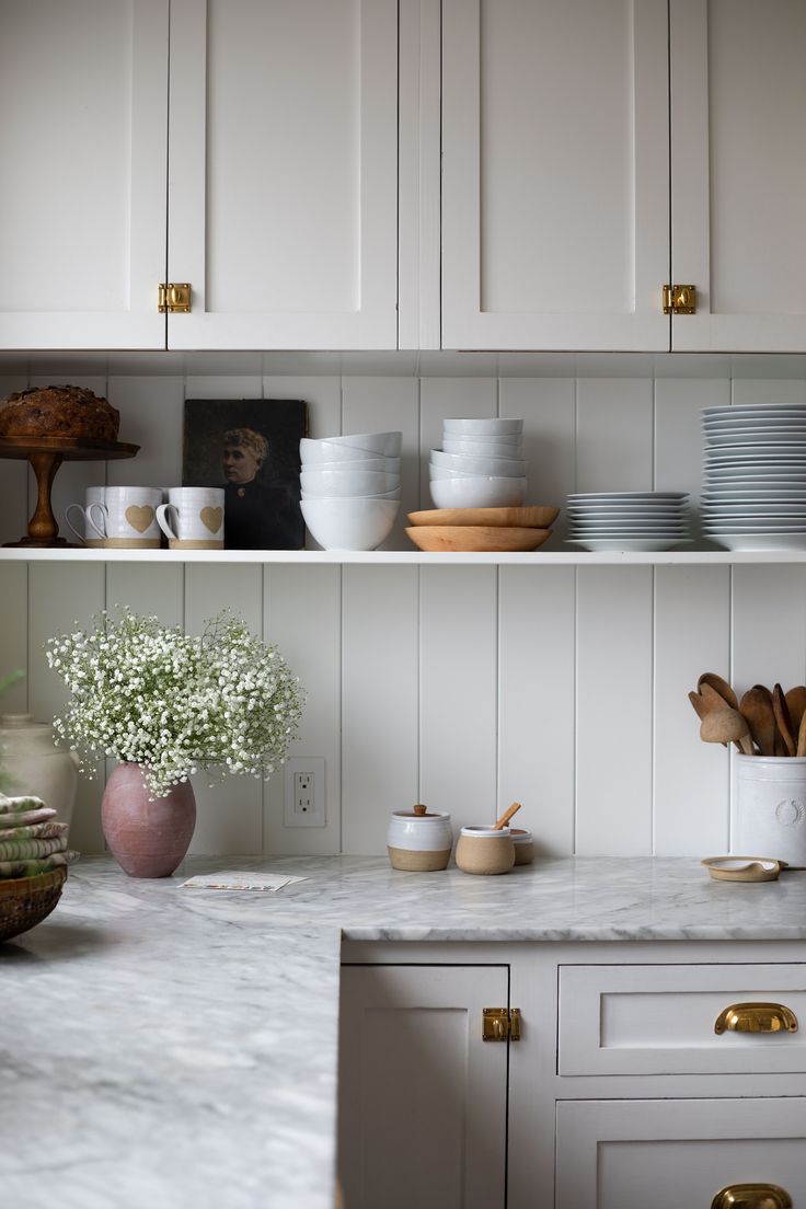 the kitchen counter is covered with dishes and cups