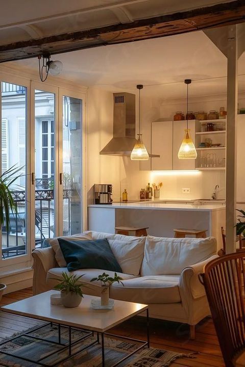 a living room filled with furniture next to a window covered in lots of light fixture