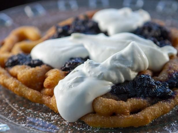 a waffle topped with whipped cream and blueberries