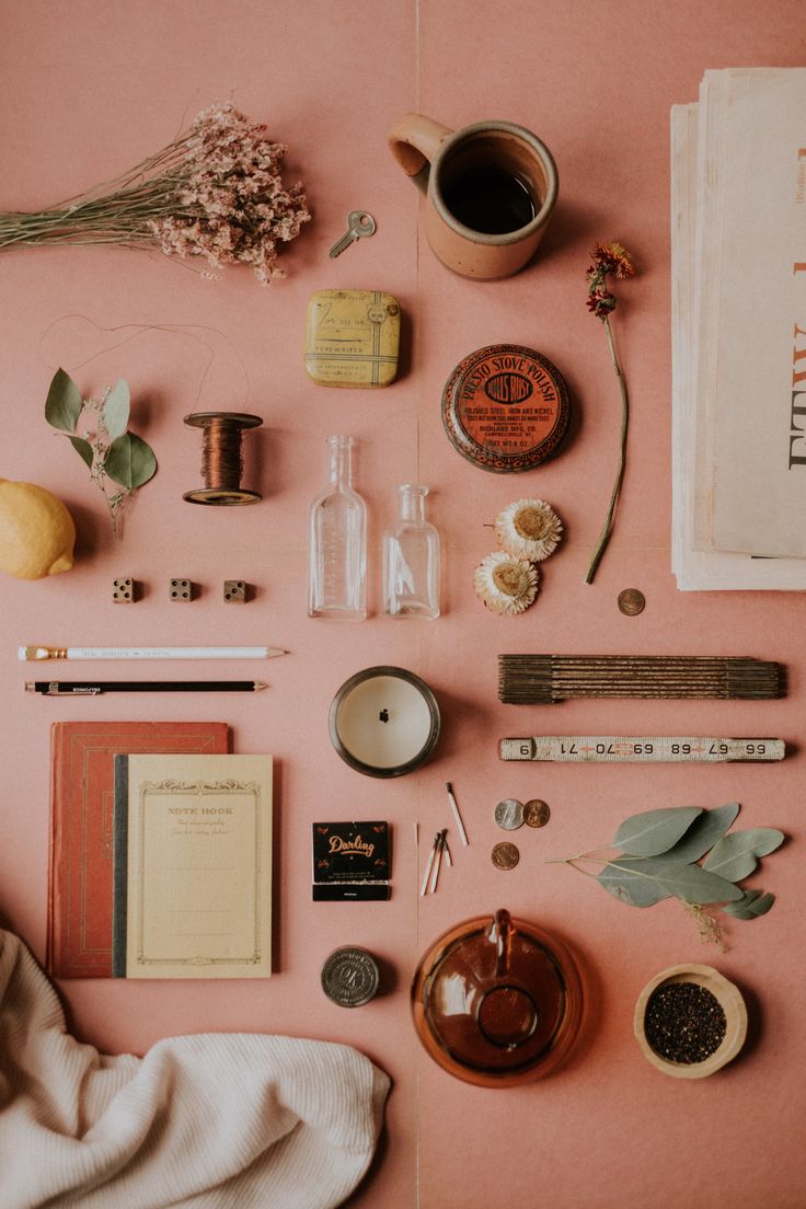 various items are arranged on a pink surface