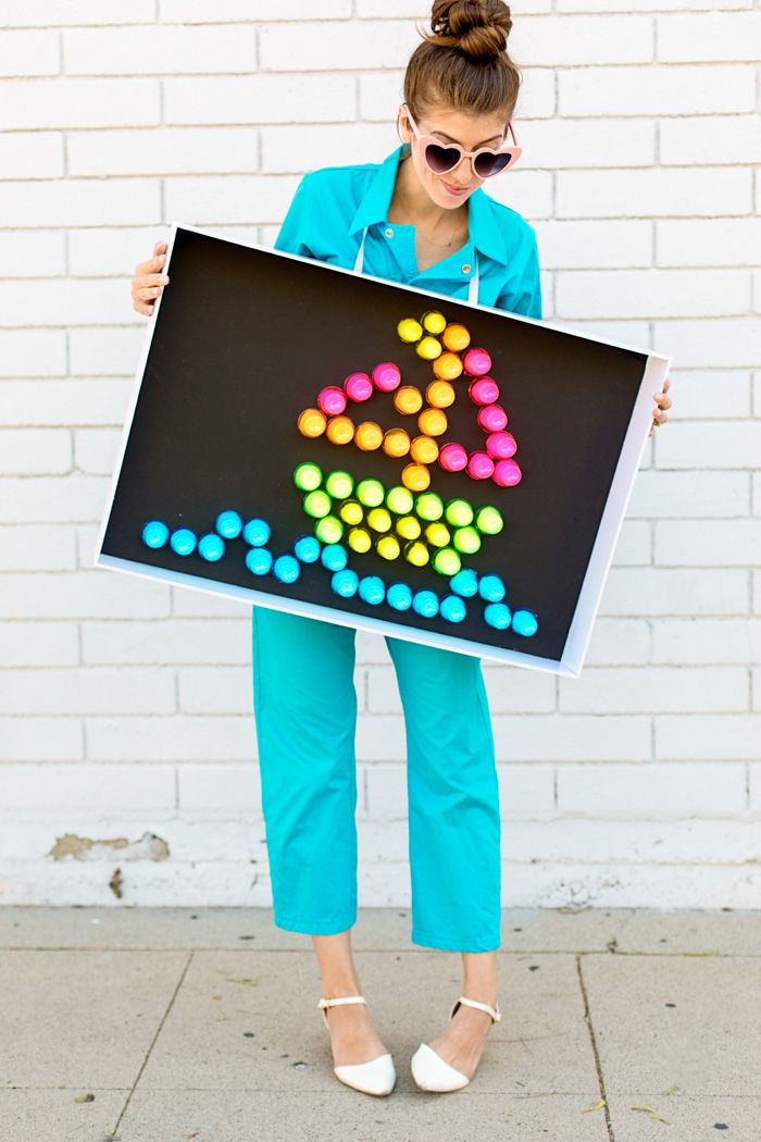 a woman is holding up a sign with dots on it