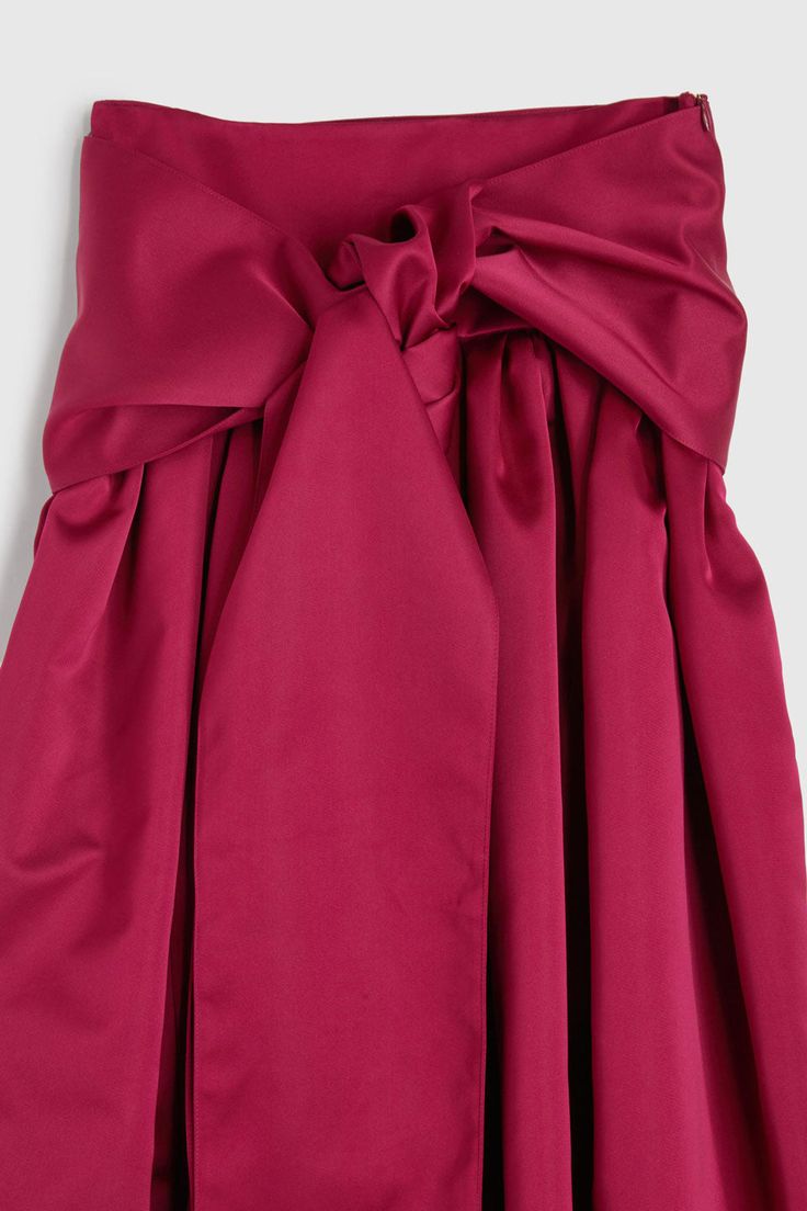 The Belted Midi Skirt in Pink by Rochas is a mid length gathered skirt featuring an oversized sash belt crafted in a pink duchesse fabrication. - 100% Polyester Formal Midi Dresses With Gathered Skirt, Silk Midi Dress With Gathered Skirt, Party Dresses With Pleated Waist And Relaxed Skirt, Elegant Tie Waist Skirt For Party, Elegant Long Skirt With Tie Waist, Formal Flared Pink Skirt, Formal Pink Flared Skirt, Pink Voluminous Skirt For Evening, Elegant Pink Pleated Skirt