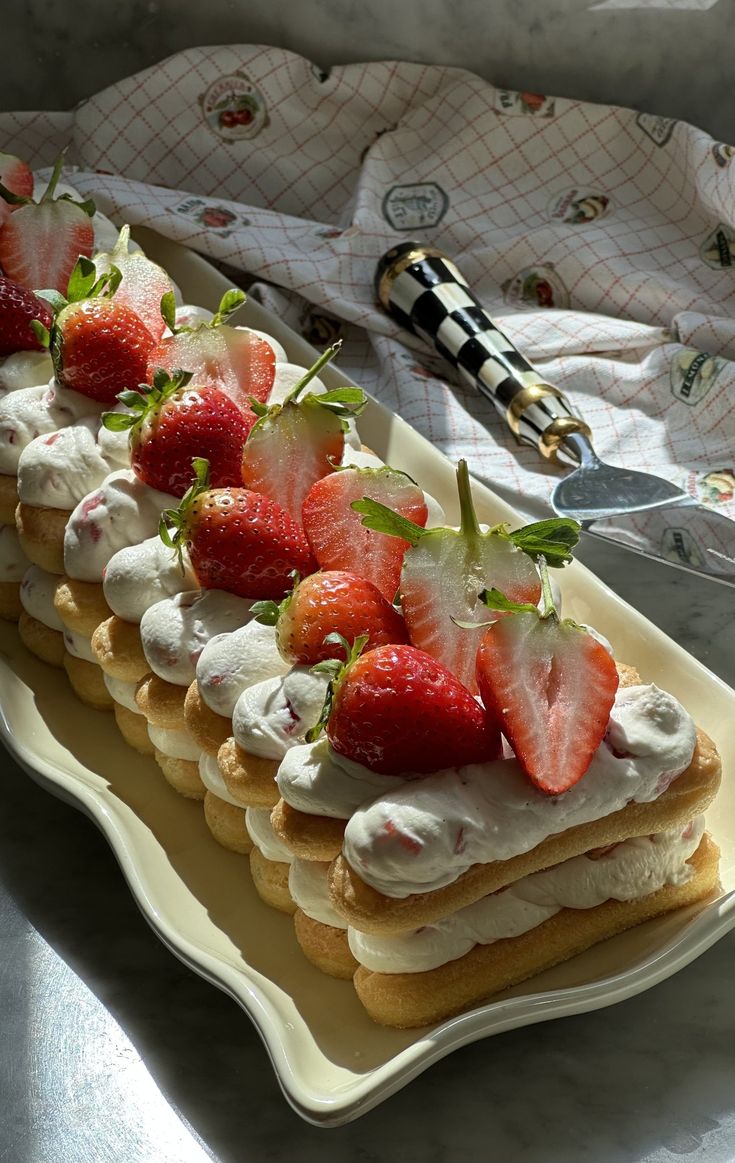 strawberry shortcakes with whipped cream and fresh strawberries on top are ready to be eaten