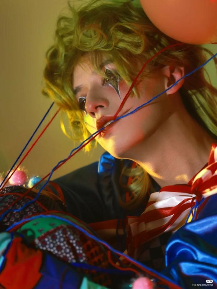 a woman with her hair blowing in the wind and balloons floating over her head,