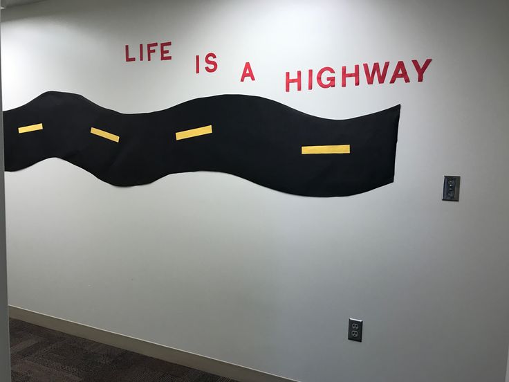 a wall with a sign that says life is a highway