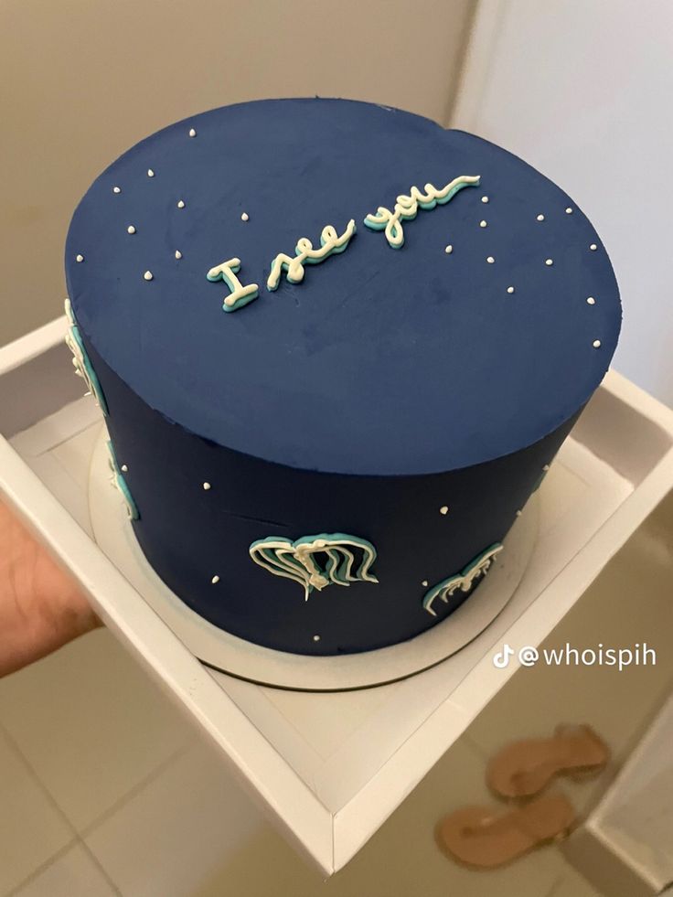 there is a blue cake that says i love you on it