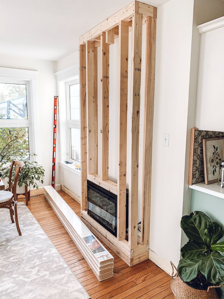 a living room filled with furniture next to a fire place in a home under construction