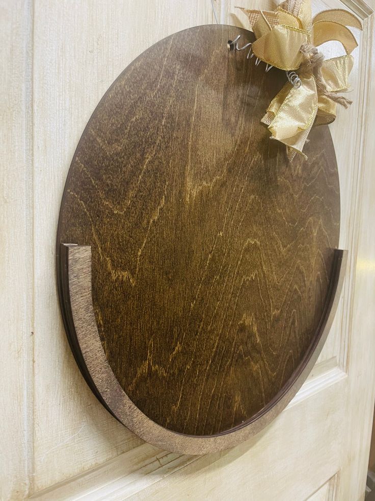 a wooden cutting board mounted to the side of a door with a flower on it