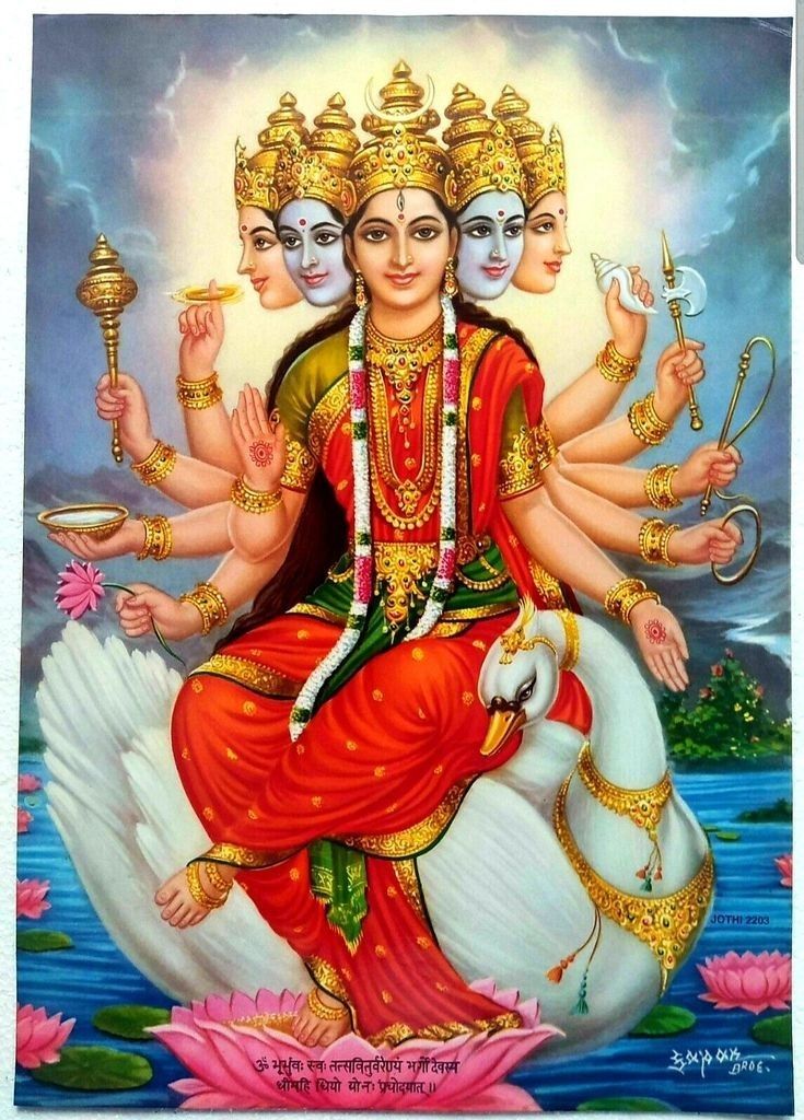 the hindu goddess sitting on top of a swan with two other deities in her lap