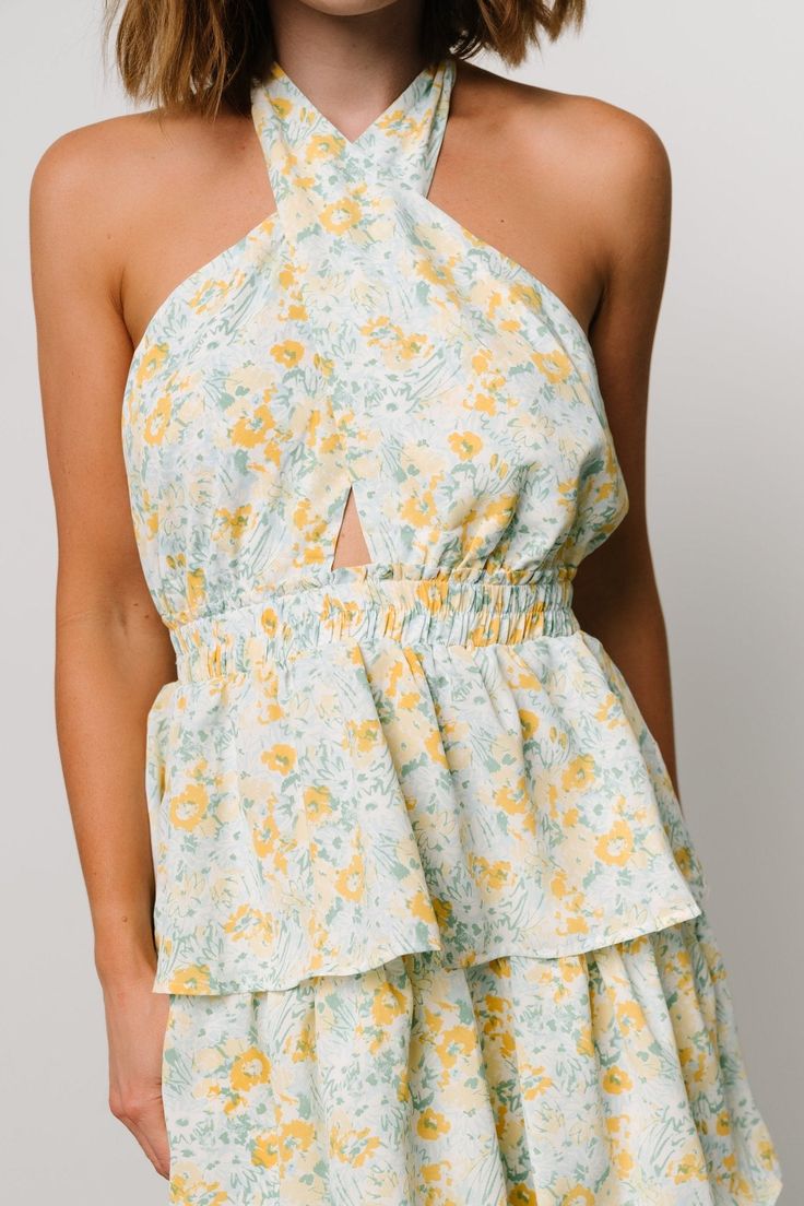 FINAL SALE A perfect piece for those fun-in-the-sun moments and memories Off white with yellow, blue, and green floral print Chiffon material has no stretch Halter neck with self-tie Open back style Elastic waistband Tiered skirt is lined until bottom tier Self and Lining: 100% Polyester Marianne is 5'6, cup size 34D, size 6 and wearing size S Spring Halter Neck Sundress For Brunch, Summer Floral Halter Neck Dress For Brunch, Summer Halter Neck Floral Dress For Brunch, Yellow Mini Floral Dress For Summer, Summer Brunch Halter Neck Floral Dress, Spring Halter Neck Sundress For Garden Party, Green Ditsy Floral Print Mini Dress For Vacation, Summer Mini Dress With Halter Neck For Spring, Yellow Floral Dress For Summer Garden Party