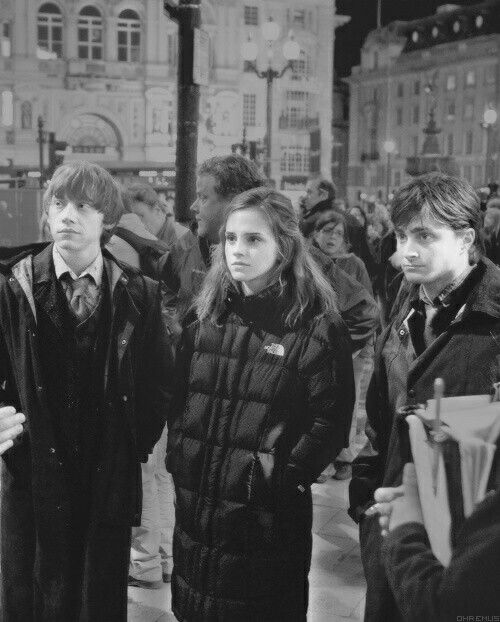 black and white photograph of people standing in the street