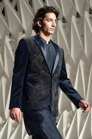 Dark teal palladian embellished tuxedo, highlighted with metallic crystals and satin detailed shawl collar.
Component: 1
Pattern: Embellished 
Type Of Work: Beads,Crystals
Neckline: Shawl Lapel Collar
Sleeve Type: Full Sleeves
Fabric: Velvet
Color: Blue
Other Details: 
Single button closure
Note: Inner kurta and trouser worn by the model is not for sale
Occasion: Party,Sangeet - Aza Fashions Luxury Embellished Party Sets, Elegant Hand Embellished Sherwani For Wedding, Elegant Formal Sets With Mirror Work, Elegant Sherwani For Festive Evening, Elegant Evening Sherwani For Festive Occasions, Designer Embellished Sherwani For Formal Occasions, Luxury Embellished Bandhgala For Wedding, Elegant Embellished Sherwani For Party, Elegant Embellished Sherwani For Wedding