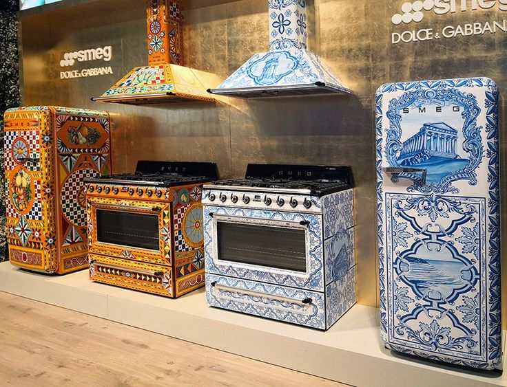 several colorful stoves and ovens on display in front of a sign that says dolce gamba