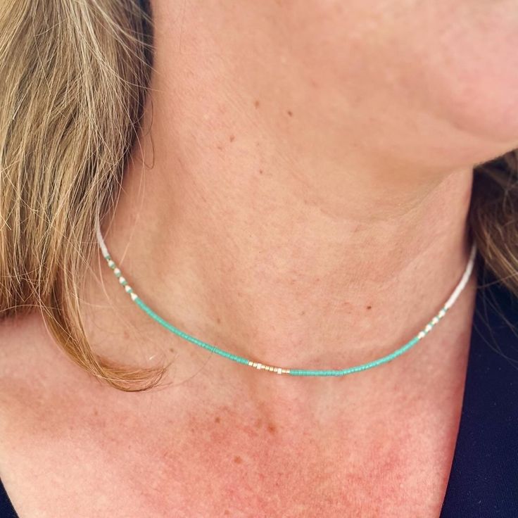 A beautifully dainty adjustable silk necklace with tiny turquoise and gold seed beads. Wear it solo or layer with others to create your unique bohemian look. It's the perfect addition to your summer accessories and a popular beach necklace.  We recommend layering with our Tiny Turquoise seed bead necklace: https://precioushippieuk.etsy.com/listing/1263330156 Hand-threaded on quality silk cord (beige colour) and secured with a 14k Gold filled slider bead. At its shortest this necklace is 16inches Turquoise Seed Bead Necklace, Silk Necklace, Beach Necklace, Turquoise And Gold, Beach Necklaces, Necklace Turquoise, Bohemian Look, Summer Necklace, Seed Bead Necklace