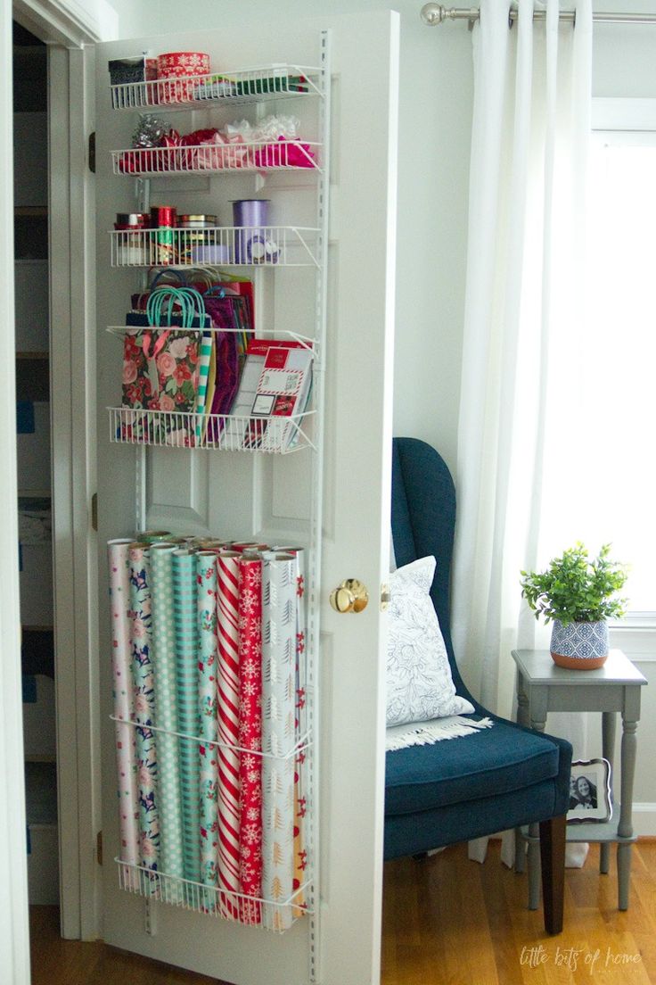 an open closet door with wrapping on the bottom shelf and other items in front of it