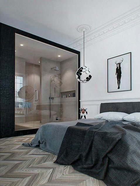 a bedroom with a bed, shower and pictures on the wall