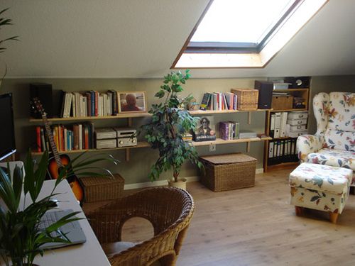 a living room filled with furniture and a skylight