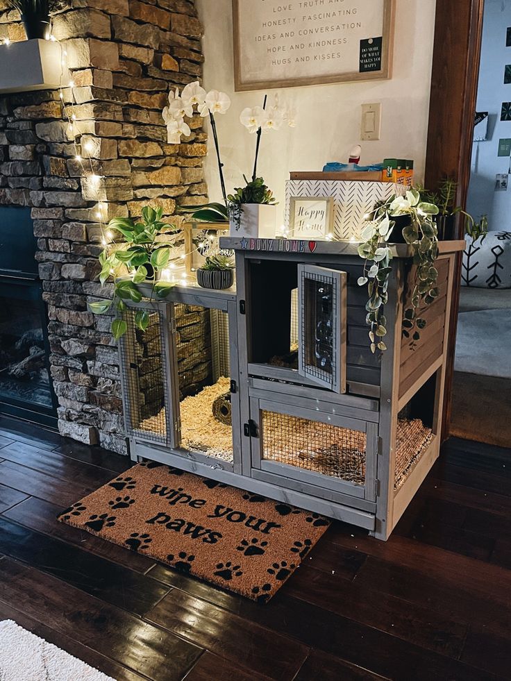 a dog house with plants and lights on the front door is shown in this living room