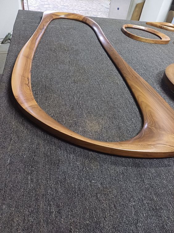 a wooden object sitting on top of a carpeted floor next to a plate and bowl