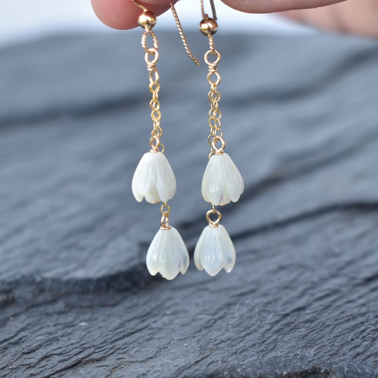 These earrings sway with your every movement and are very flattering! Two carved mother of pearl Pikake beads dangle gently from your choice of sterling silver or gold fill chain. This material will not tarnish and can even get wet! White Linear Pierced Earrings For Gift, White Linear Pierced Earrings As Gift, White Linear Earrings As A Gift, White Threader Earrings For Pierced Ears As Gift, White Threader Earrings With Ear Wire For Gift, White Threader Earrings As A Gift, White Long Drop Earrings For Gift, White Dangle Threader Earrings, White Teardrop Linear Earrings Dainty Style