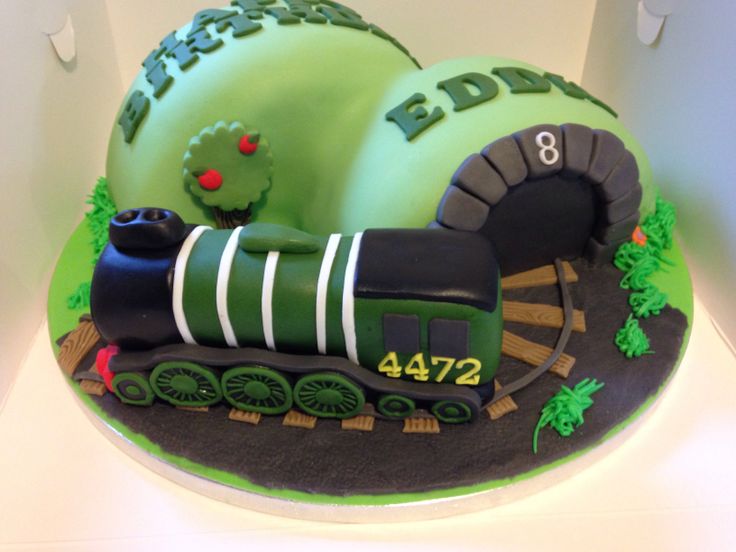 a birthday cake that is shaped like a train