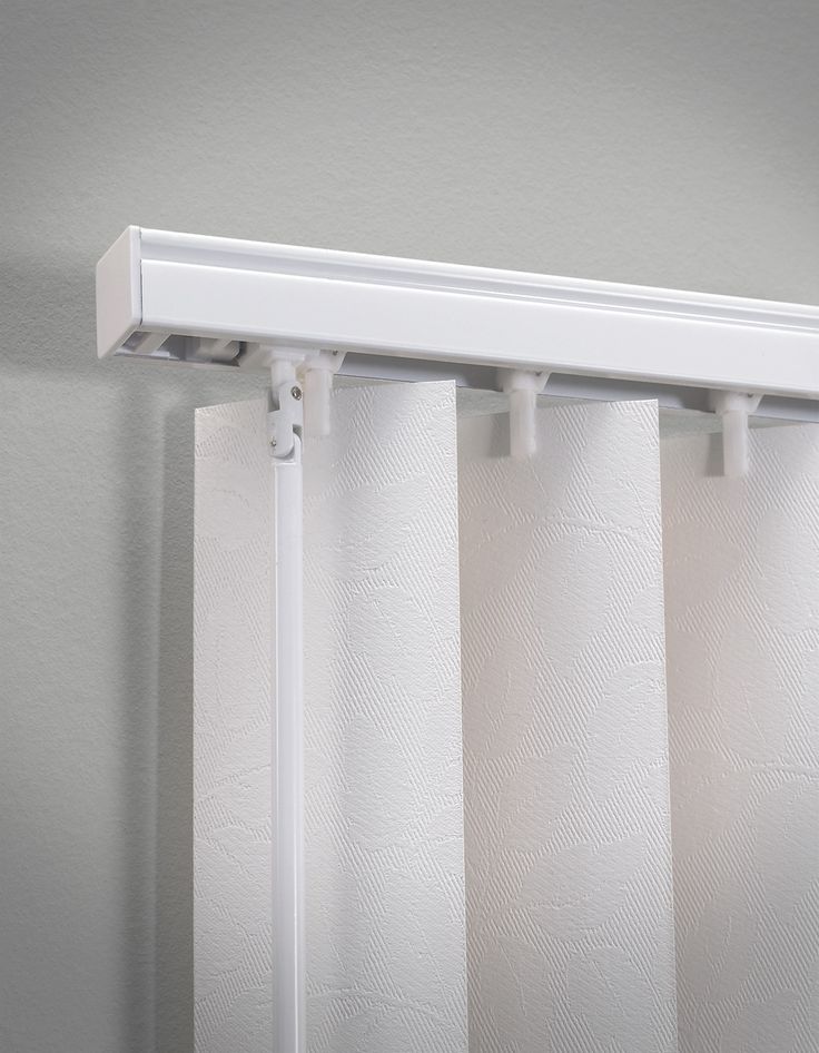 a white curtain rod is hanging on the wall