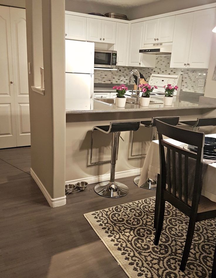 the kitchen is clean and ready to be used as a dining room or living room