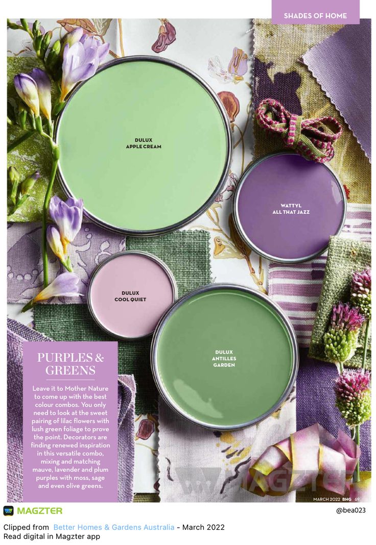 some green and purple paint colors are on the cover of a magazine, with flowers in the background