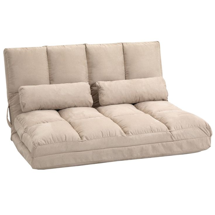 a beige futon couch with pillows on it's back and side facings