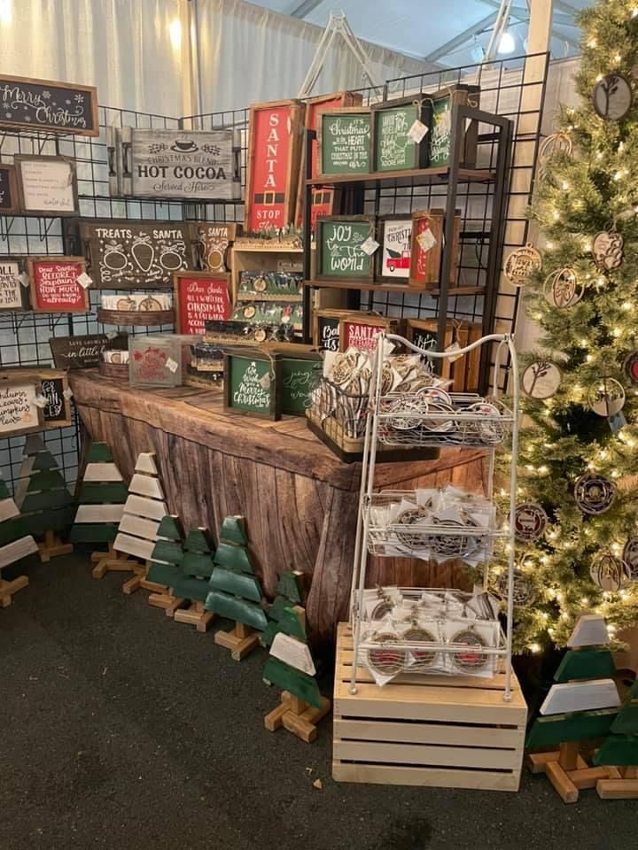 a christmas display in a store filled with lots of holiday decorations and signs on the wall