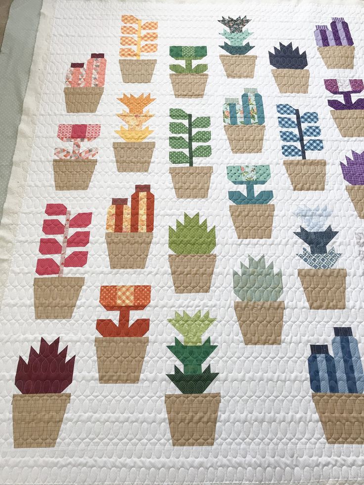 a quilted potted plant pattern is displayed on a table top with other plants