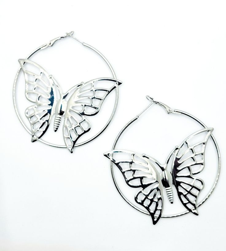 These stunning butterfly-shaped hoop earrings, available in both silver and gold, will add a touch of elegance and whimsy to any outfit. These meticulously crafted earrings are designed to make you feel confident, graceful, and captivating wherever you go. Silver Earrings With Butterfly Charm, Nickel-free Silver Butterfly Earrings, Nickel-free Butterfly Shaped Silver Earrings, Silver Butterfly Charm Earrings, Sterling Silver Butterfly Charm Earrings, Elegant Metal Earrings With Butterfly Charm, Silver Drop Earrings With Butterfly Charm, Nickel-free Butterfly Jewelry For Party, Trendy Butterfly Hoop Earrings As Gift