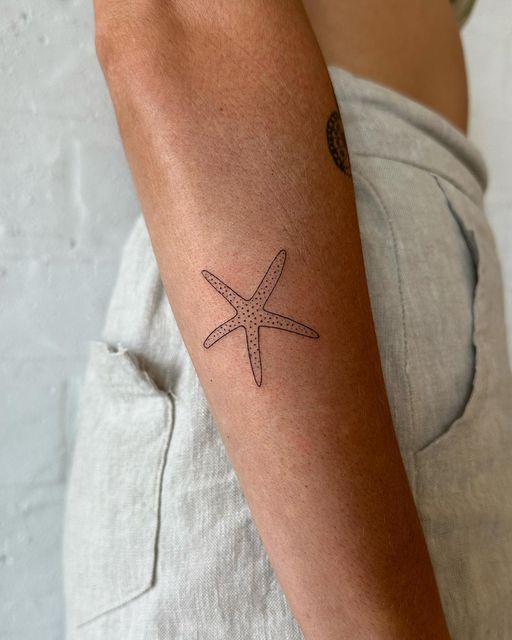 a man with a starfish tattoo on his arm