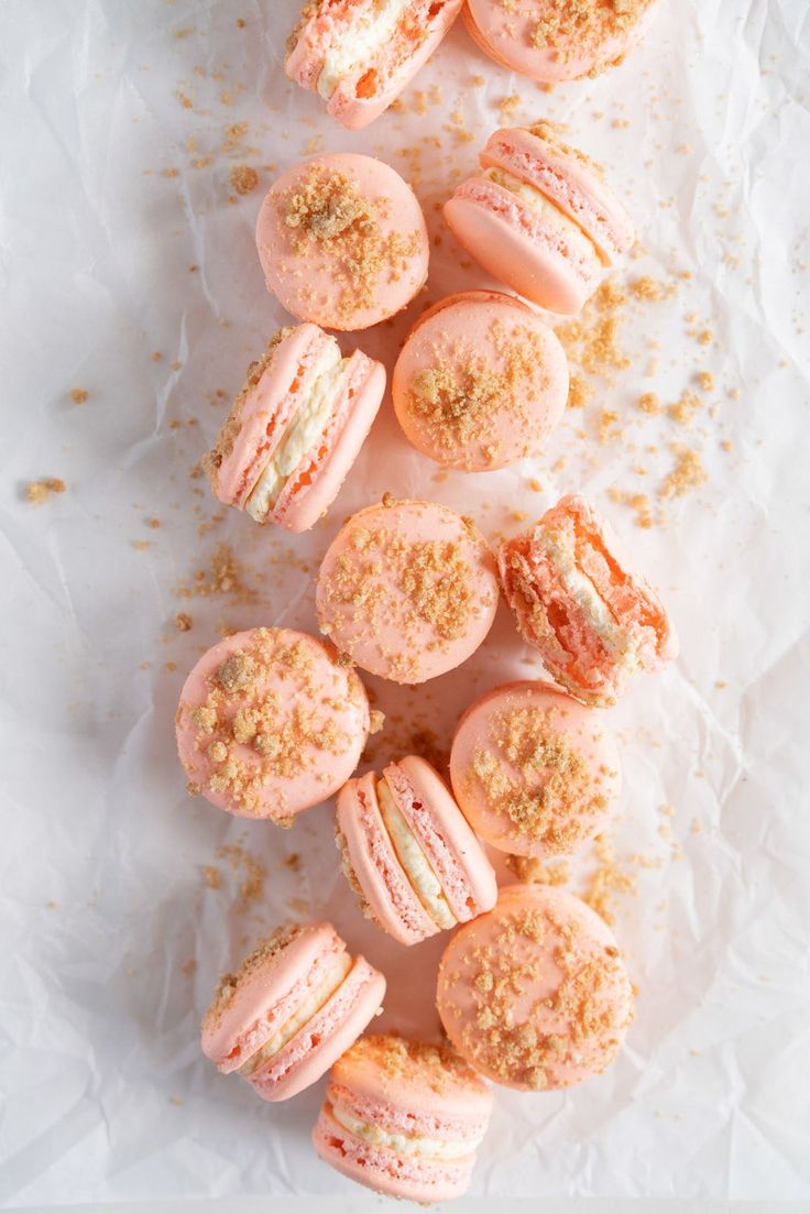 pink macaroni and cheese covered in powdered sugar on top of white paper