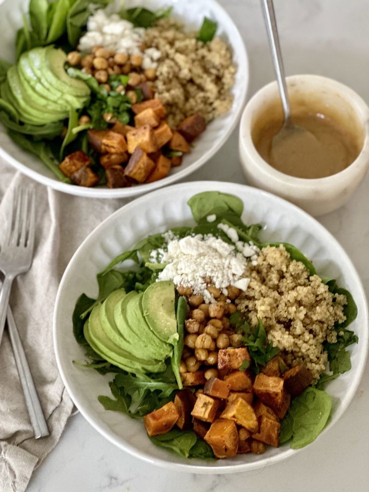 two white bowls filled with salad and dressing