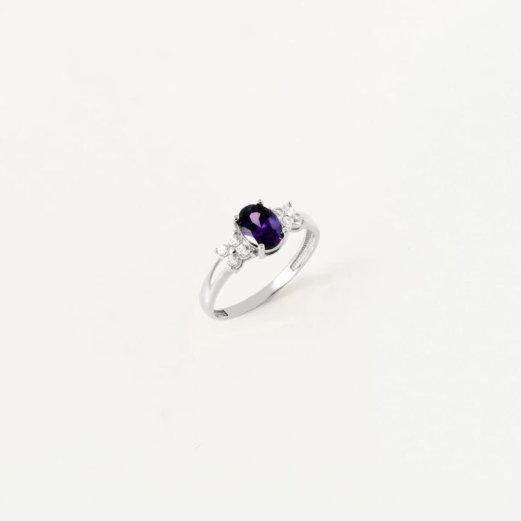 This exquisite ring whispers tales of twilight with its enchanting design and serene aura. Handcrafted with meticulous attention to detail, it exudes an air of elegance that speaks volumes of sophistication and style. Adorned with an oval-cut amethyst birthstone and complemented by CZ accents, this ring captures the essence of February birthdays. The amethyst, a symbol of serenity and spirituality, adds a touch of mystique and allure to the piece, making it a perfect gift for those born in this Timeless Purple Rings Perfect For Gifts, Timeless Purple Rings As Gifts, Timeless Purple Rings For Gifts, Classic Cubic Zirconia Birthstone Ring, Elegant Diamond Ring With Gemstone Accents For Gift, Heirloom Style Solitaire Birthstone Ring As A Gift, Heirloom Solitaire Birthstone Ring Gift, Timeless Sapphire Ring With Center Stone As Gift, Classic Gemstone Birthstone Ring For Promise