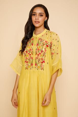 Yellow dress with floral embroidery around the neckline and mandarin collar. Comes with inner slip.
Component: 2
Embroidered
Neckline: Mandarin Collar
Sleeve Length: Three Quarter
Fabric: Chanderi Cotton
Color: Yellow
Front button placket - Aza Fashions Yellow Embroidered Straight Kurta Dress, Yellow Straight Kurta Dress With Intricate Embroidery, Summer Straight Kurta Dress With Multicolor Embroidery, Summer Multicolor Embroidered Straight Kurta, Elegant Embroidered Neckline Dress For Festivals, Elegant Dresses With Embroidered Neckline For Festivals, Festive Yellow Embroidered Dress With Floral Details, Straight Kurta With Multicolor Intricate Embroidery, Festival Anarkali Dress With Embroidered Neckline