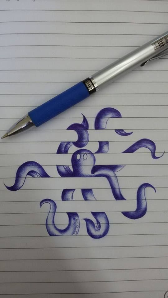 a pen sitting on top of a piece of paper next to an ink drawing octopus