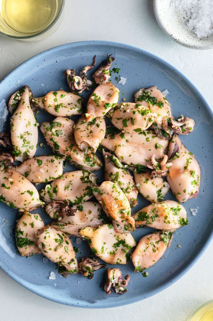 a blue plate topped with chicken and mushrooms