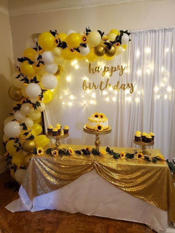 a birthday party with sunflowers and balloons