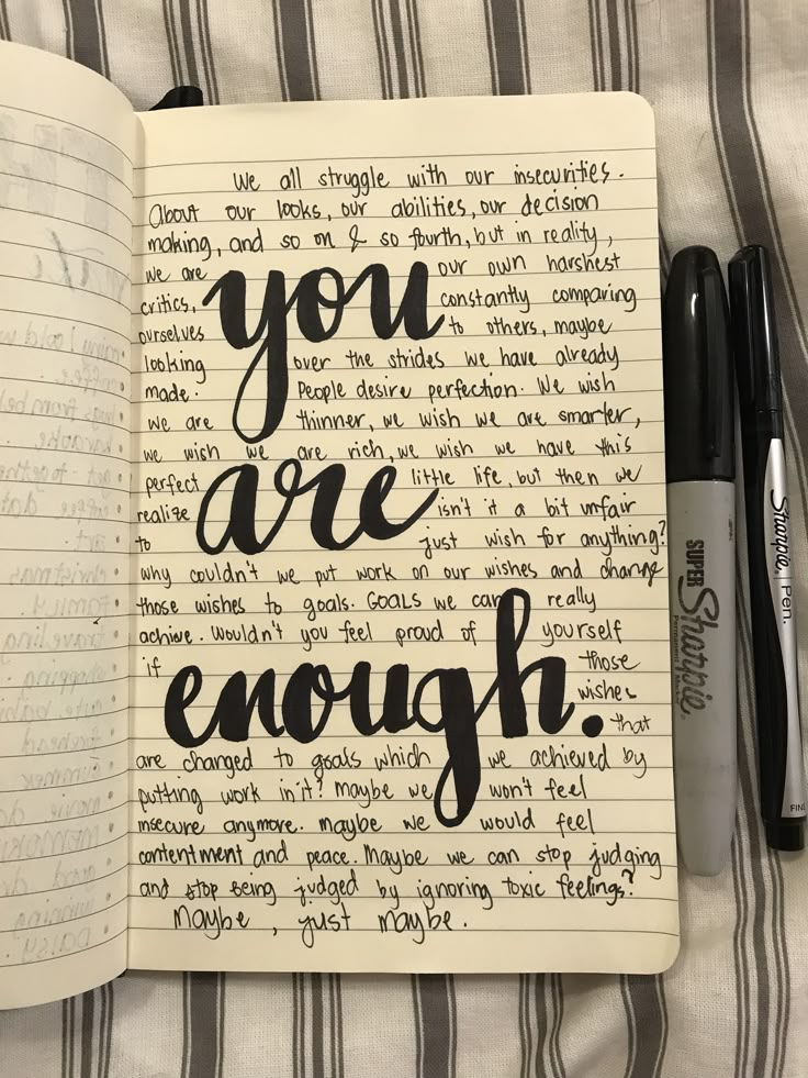 an open notebook with the words you are enough written in cursive writing