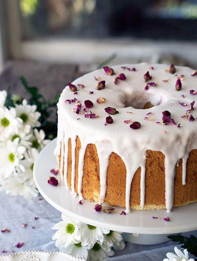 a bundt cake with white icing and flowers