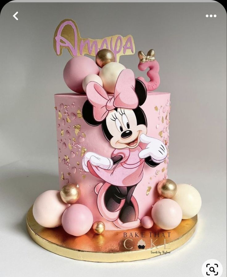 a pink and gold minnie mouse birthday cake