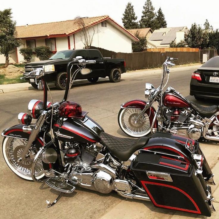 two motorcycles parked next to each other on the side of the road in front of a car