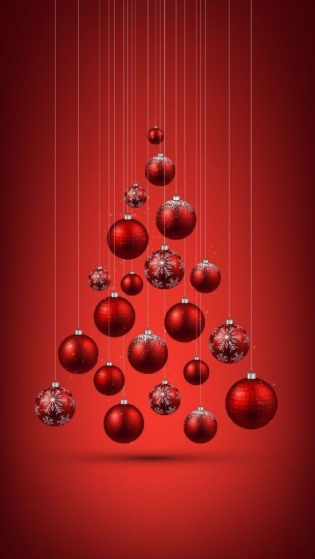 a red christmas tree with ornaments hanging from it's sides on a red background