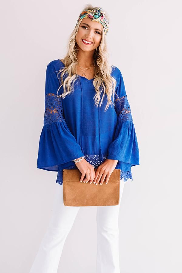 We think you'll agree when we tell you how "haute" this charming royal blue top is featuring lightweight breezy material with intricate semi-sheer crochet detailing, a v-cut neckline with a tie closure, long oversized sleeves with ultra flared forearm cuffs, and a relaxed silhouette that falls into a scalloped tunic length hemline! We have styled this cutie with some white flares, a matching headband, and a brown wedge and clutch, but you can also wear it with some distressed light wash shorts a Royal Blue Top, Brown Wedges, White Flares, Matching Headband, Tunic Length, V Cuts, Royal Blue, Crochet Top, Bell Sleeve Top